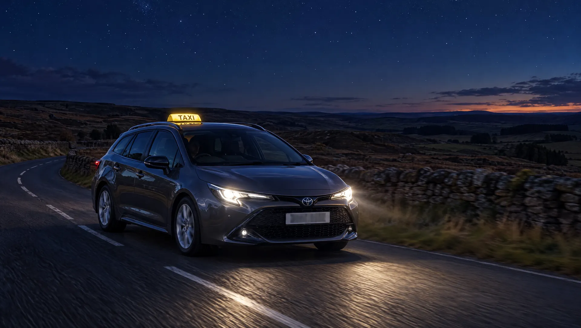 The JimGO taxi with its roof sign lit on a Northumberland country road at night